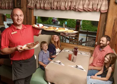 server giving family their meal at Log Cabin Pancake House