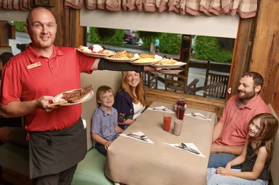 server bringing meal to family