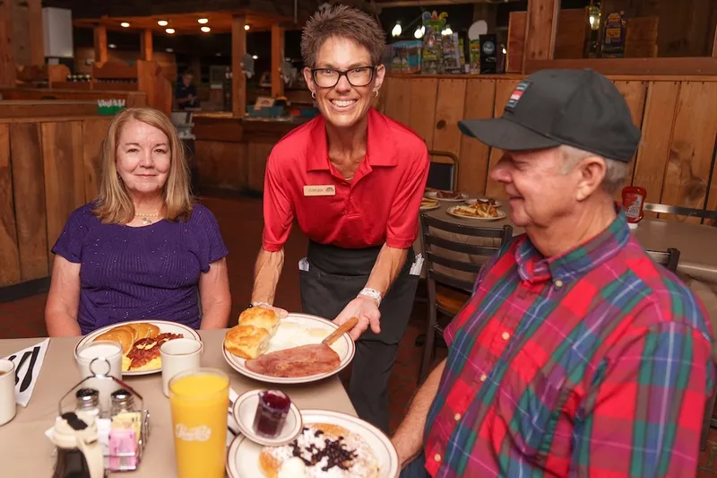 server delivering food to couple